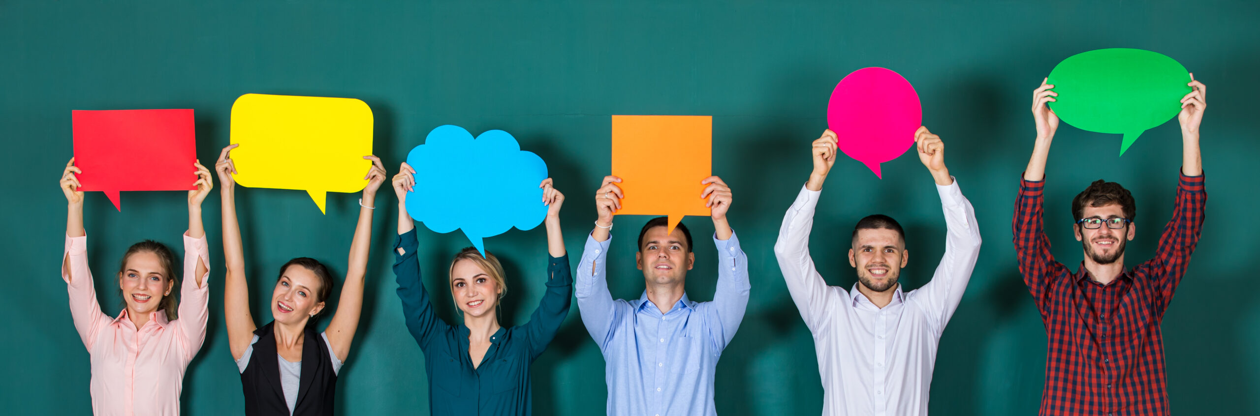 Group of six business people team standing together and holding colorful and different shapes of speech bubbles.